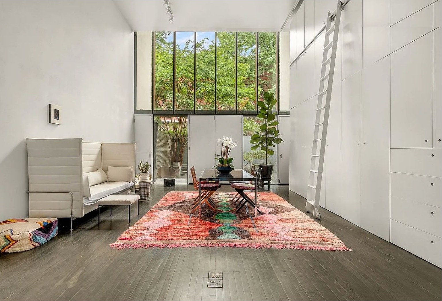 Two-story great room with tall windows and a colorful rug at 208 Vanderbilt Ave