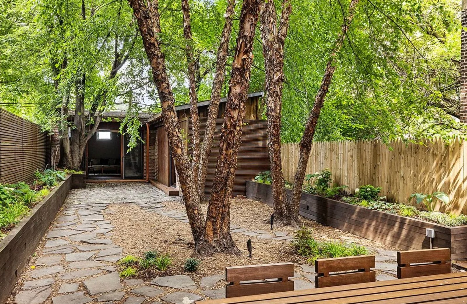Stone courtyard backyard with birch trees